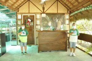 two people wearing face masks standing in front of a counter at Paseo Verde Beach Resort in Laiya +291 photos