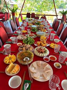 a long table full of food on a red table at Lâm Viên Hotel & Retreat in Kon Rung (1)