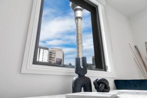 a pair of scissors sitting in front of a window at Sky Tower View with Rooftop Pool! in Auckland