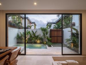 an open living room with a pool and a house at La Finca Bingin in Uluwatu +73 photos