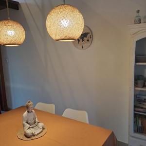 a statue of a buddha sitting on a table at Arena Duplex in Necochea