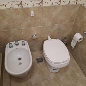 a bathroom with a toilet and a bidet at Arena Duplex in Necochea +10 photos