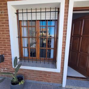 a window in a brick building with a door at Arena Duplex in Necochea