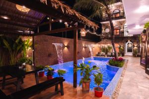 a pool in the middle of a building with plants at Serena Tam Coc Hotel & Villa in Ninh Binh