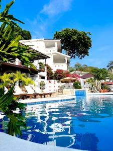 a swimming pool in front of a villa at Steps Garden Resort in Sabang