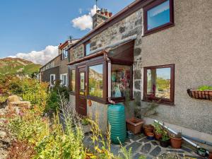 a house with a water tank outside of it at 1 Bed in Conwy 92421 in Penmaen-mawr