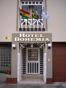 a hotel door with two flags on top of it at Hotel Bohemia in Lima