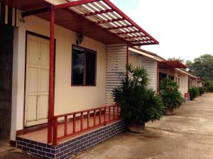 a house with a red railing and a porch at Zigzag Resort in Ban Som Poi