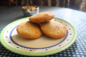 three biscuits on a plate on a table at Flagship The Address in Deolāli +45 photos