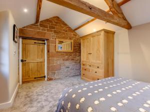 a bedroom with a bed and a brick wall at 2 Bed in Dalston 93820 in Dalston
