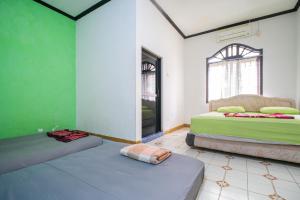 Postel nebo postele na pokoji v ubytování MW 46 Guest House Jogja