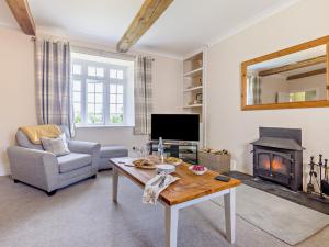 オークハンプトンにある6 Bed in Okehampton ESTRAのテーブルと暖炉のあるリビングルーム