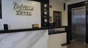 a counter in a store with clocks on the wall at Devera Hotel in Angeles