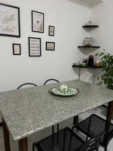 a table with chairs and a plate with a cake on it at Angy's Home in Corsico +7 photos
