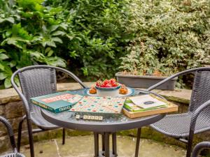 a table with a bowl of fruit and books on it at 2 bed in Ilkley 89554 in Ilkley