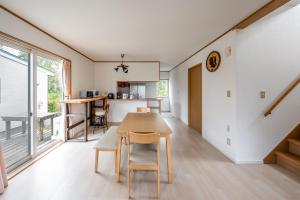 a kitchen and living room with a table and chairs at Toya Serenity Stay in Lake Toya