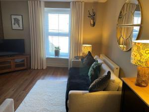 a living room with a couch and a window at 1 Bed in Pateley Bridge 88520 in Pateley Bridge