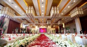 a banquet hall with white chairs and red and white flowers at Sichuan Tennis International Hotel Main Building in Chengdu +262 photos