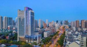 a city skyline with tall buildings and a street at Wuhan Tieqiao Jianguo Hotel in Wuhan