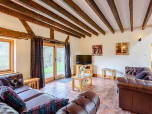 a living room with two couches and a tv at 4 Bed in Bettws Cedewain 86784 in Bettws Cedewain