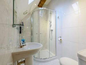 a white bathroom with a shower and a sink at 4 Bed in Bettws Cedewain 86784 in Bettws Cedewain +27 photos