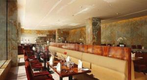 a dining room with a long table and chairs at Hotel Leader Changsha in Changsha