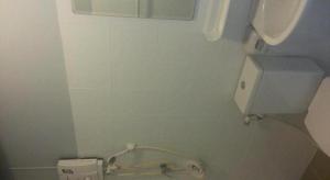 a bathroom with a toilet with a paper dispenser at A+ Hotel in Ban Na Khwai +55 photos