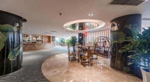 a dining room with a table and some plants at Chengdu Yinsheng International Hotel in Chengdu