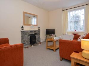 a living room with a fireplace and a television at 2 Bed in Bideford 37262 in Bideford