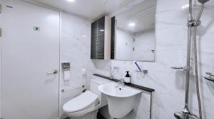 a white bathroom with a toilet and a sink at Daegu 3 rooms APT All furnished Near downtown & Dongdaegu station in Daegu +54 photos