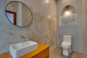 a bathroom with a sink and a toilet and a mirror at Sweet Escape 1BR Matahari LaLuxe A22 Sanur Villa in Sanur +16 photos
