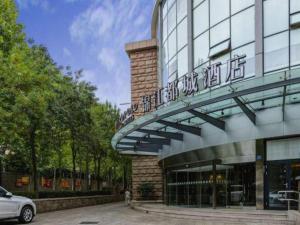 a car parked in front of a building at Metropolo Hotel Qingdao Wusi Square Xiaomaidao in Qingdao