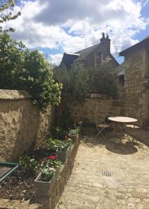 a patio with a table and a table and some plants at Aquarelle in Sainte-Maure-de-Touraine +44 photos