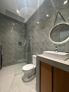 a bathroom with a toilet and a sink and a mirror at Pondok Metis in Tumbak Bayuh +24 photos