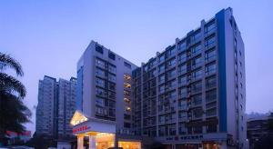 a large building in a city with buildings at Vienna Hotel Chengdu Chunxi Road Lijiatuo Metro Station in Chengdu