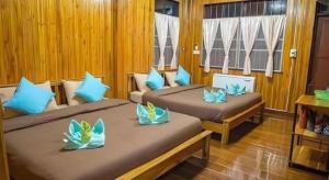 two beds in a room with blue pillows on them at BankongRimkhong Chiangkhan in Chiang Khan