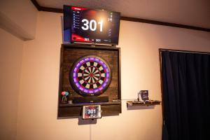a dart board and a scoreboard on a wall at CINEMA RESORTS 4 in Motobu