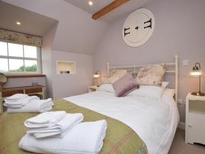a bedroom with a large bed with white towels on it at 2 Bed in Peebles 76383 in West Linton