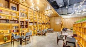 a restaurant with tables and chairs in a library at James Joyce Coffetel·Anyang Text Museum in Anyang