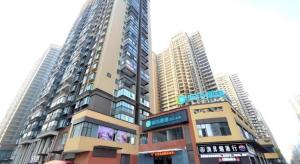 a tall building in front of some tall buildings at City Comfort Inn Wuhan Guanggu Textile University in Wuhan