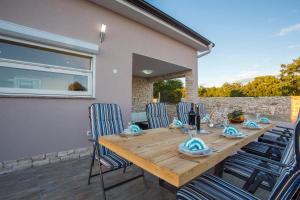 a wooden table and chairs on a patio at Galizana Peaceful Vacation home in Galižana