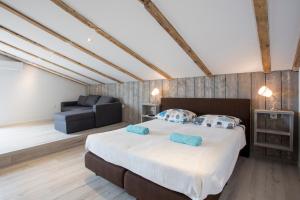 a bedroom with a large bed and a couch at Galizana Peaceful Vacation home in Galižana +53 photos