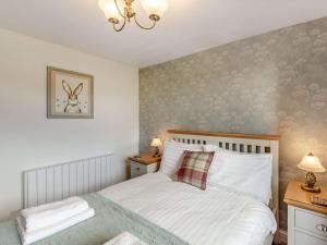 a bedroom with a bed and two night stands at 2 Bed in Hawkshead 89748 in Hawkshead
