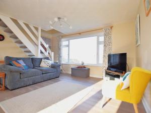 a living room with a couch and a tv at 3 Bed in Porthtowan 90556 in Porthtowan