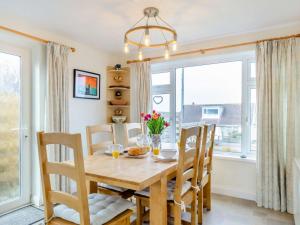 a dining room with a table and chairs and a window at 3 Bed in Porthtowan 90556 in Porthtowan