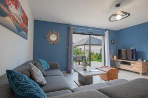 a living room with a couch and a table at Entre genêts et chardons in Banassac