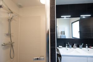 a bathroom with a sink and a shower with a mirror at Entre genêts et chardons in Banassac +25 photos
