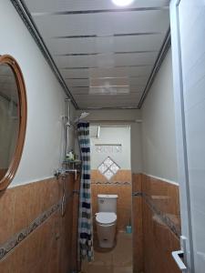 a small bathroom with a toilet and a sink at Bahrin Homestay Lampung in Kedaton +12 photos