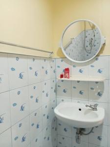 a bathroom with a sink and a mirror at Wattana Bungalow in Nai Yang Beach