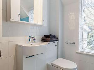 a white bathroom with a toilet and a sink at 2 Bed in Bovey Tracey PRIMC in Hennock +23 photos